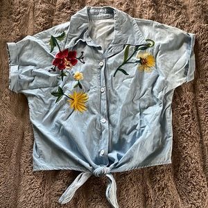 Never worn, cute button down bottom tie embroidered shirt. Light blue.